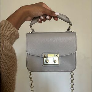 Taupe handbag with gold chain crossbody strap